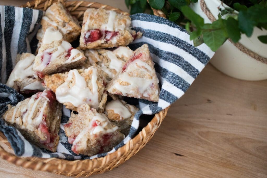 fresh strawberry sourdough scones with maple cream frosting