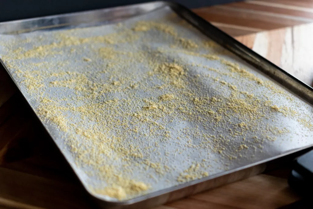 cornmeal on a baking sheet