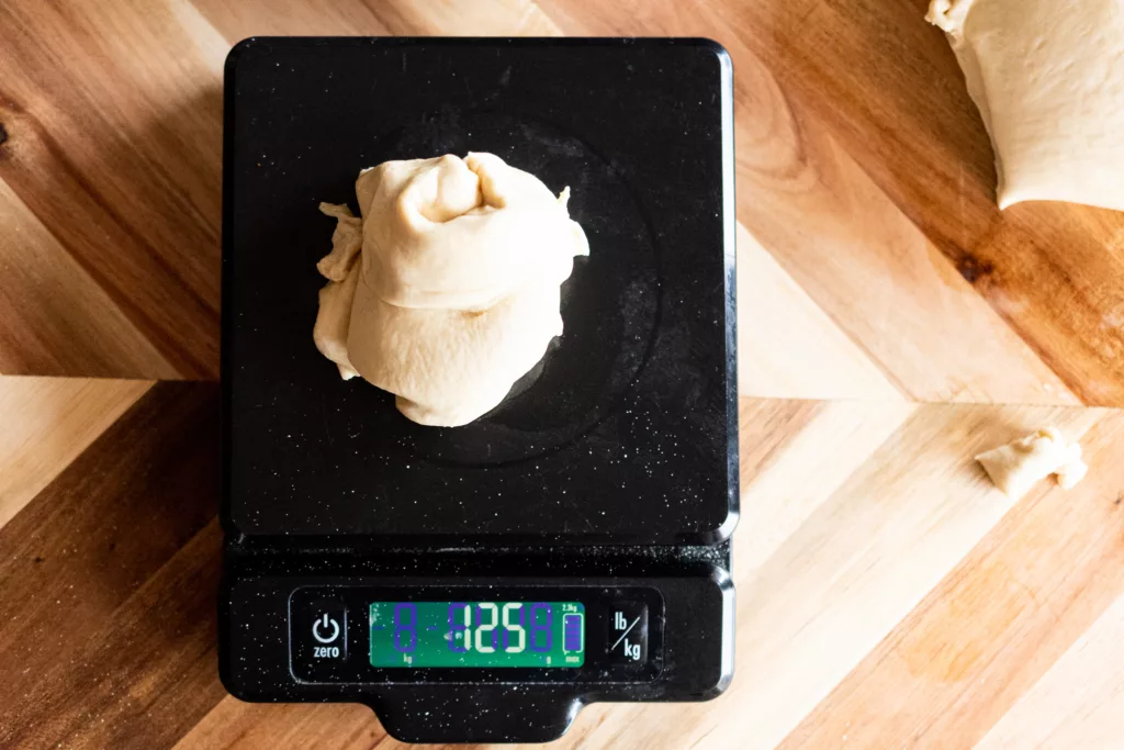 a lump of bagel dough on a scale