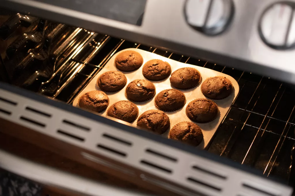 chocolate muffins baking in oven