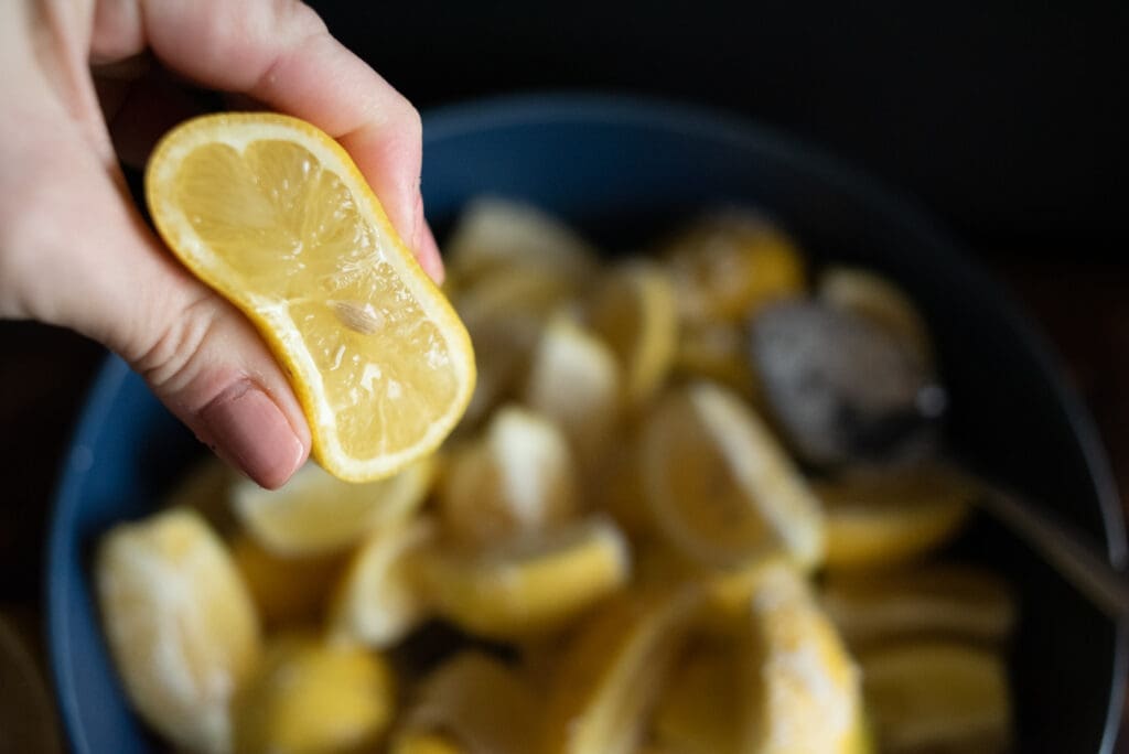 squeeze one lemon over the preserved lemons